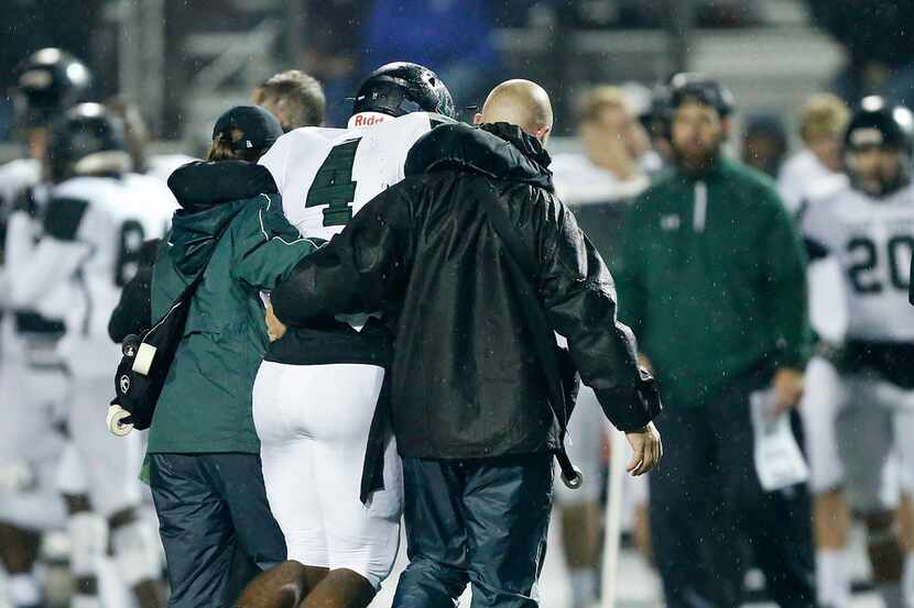 Mansfield Lake Ridge quarterback Chandler Rogers is helped off the field after sustaining a...