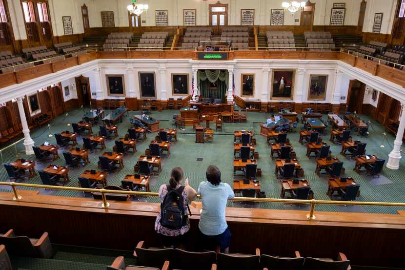 Haley Solomon (left) and Joseph Solomon from Maryland look out from the gallery of the Texas...