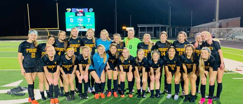 Forney's Chloe Chadwick (No. 9) poses for a group photo with teammates after defeating North...