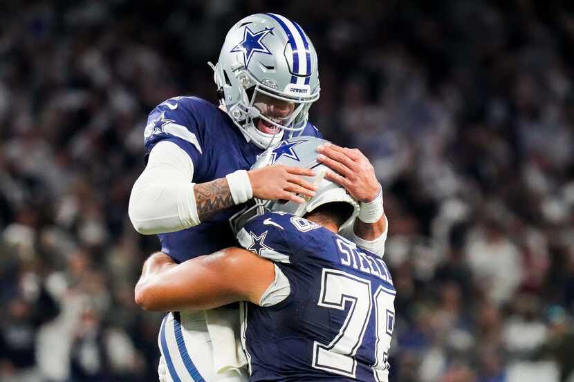 Dallas Cowboys quarterback Dak Prescott (4) celebrates with offensive tackle Terence Steele...