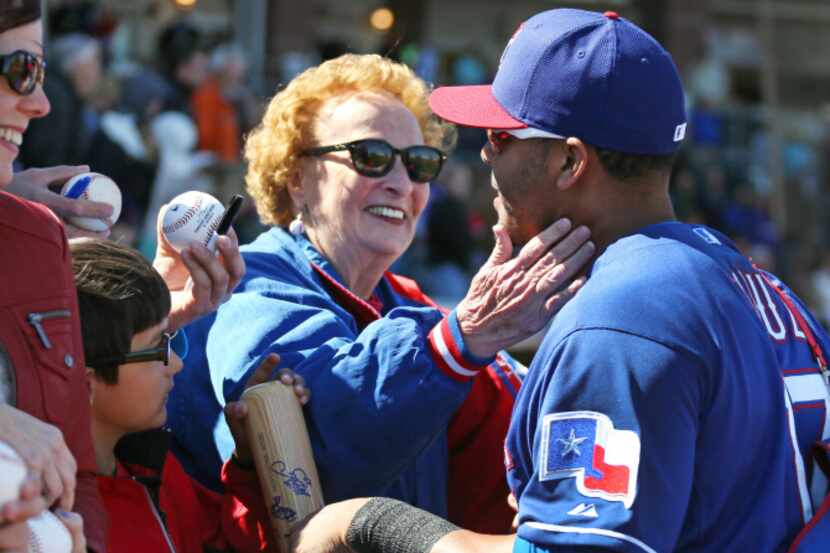 Texas Rangers fan Shirley Kost, known as the Cookie Lady, greets Texas outfielder Nelson...