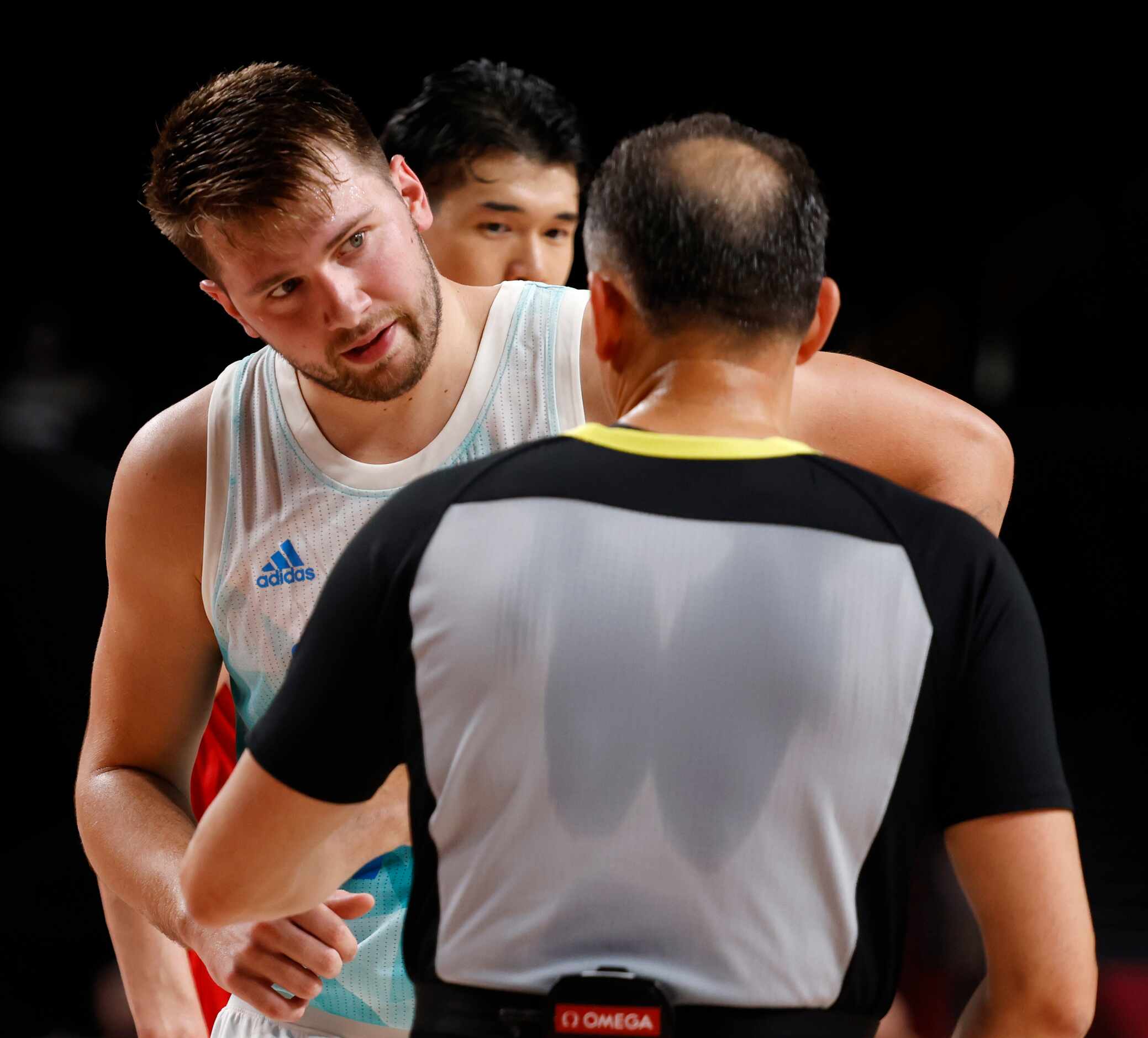 Slovenia’s Luka Doncic talks to an official during a basketball game against Japan in the...