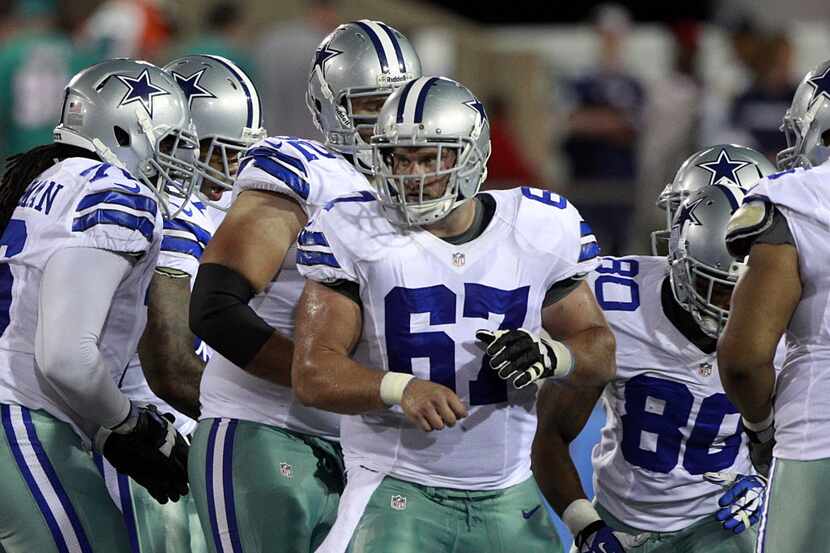 Dallas Cowboys center Phil Costa (67) breaks form the huddle against the Miami Dolphins in...