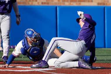 TCU's Ryder Robinson, right, is tagged out by Kansas catcher Jake English after attempting...