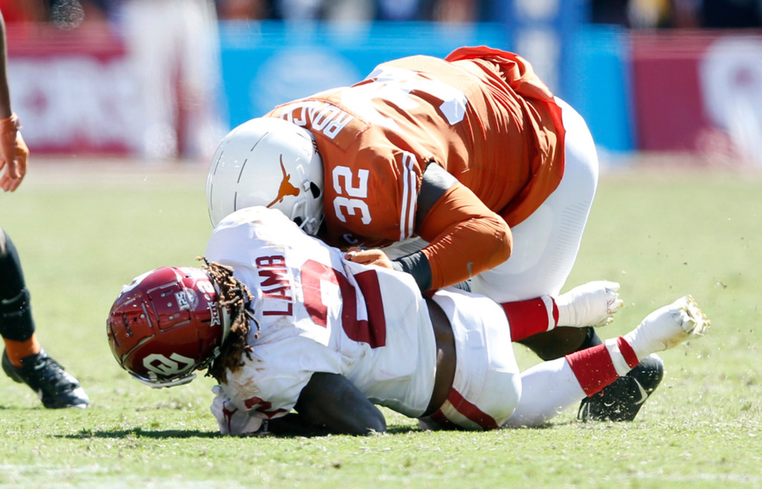 Texas Longhorns defensive lineman Malcolm Roach (32) hits Oklahoma Sooners wide receiver...