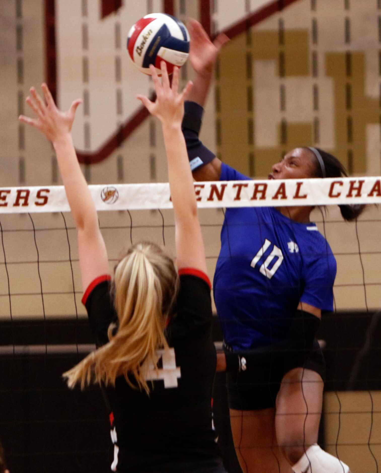 Trophy Club Byron Nelson outside hitter Charitie Luper (10) fires a spike past the defense...