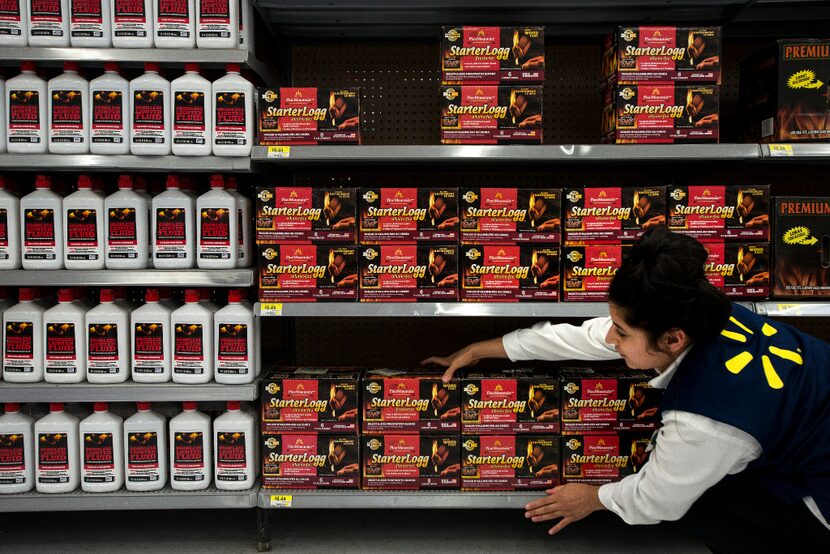 A Walmart Academy student straightens products at the Walmart in Fayetteville, Ark. (Melissa...