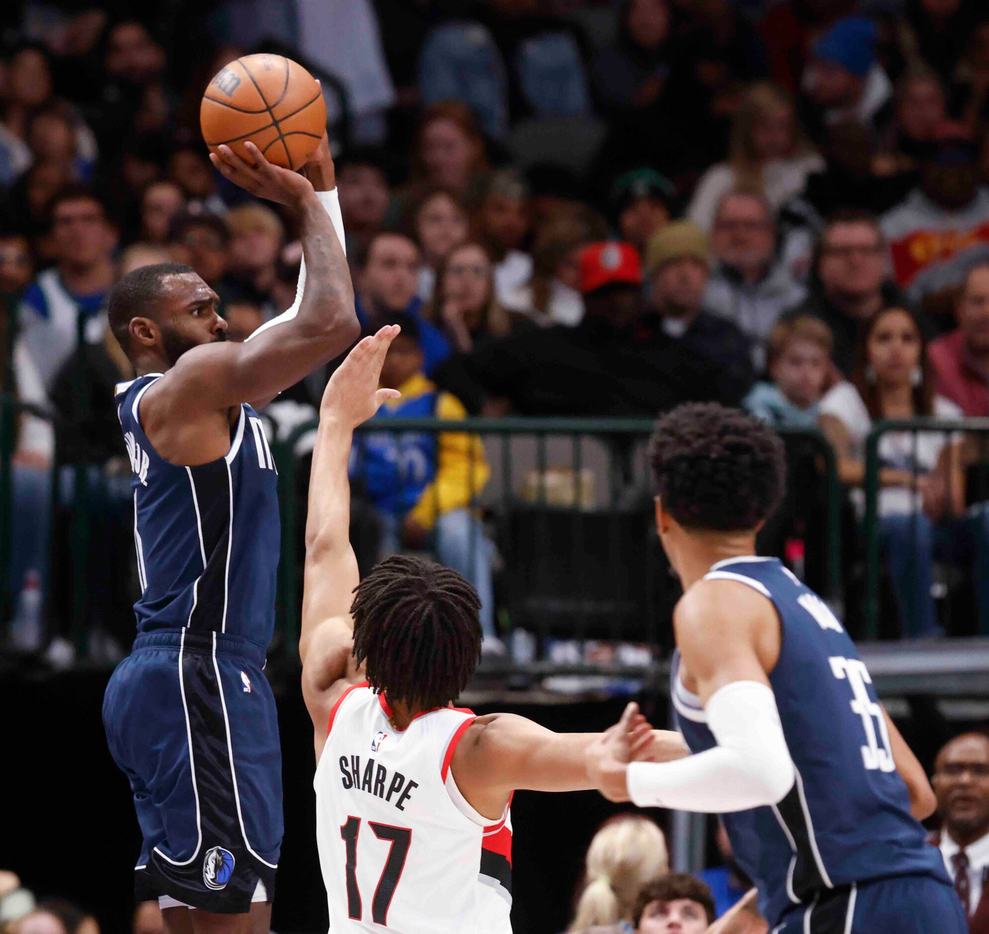 Dallas Mavericks forward Tim Hardaway Jr. (11) shoots a three pointer past Portland Trail...