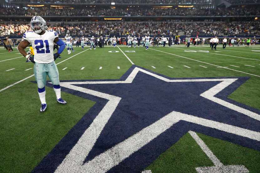 Dallas Cowboys' Ezekiel Elliott (21) stands on the field after an NFL football game against...