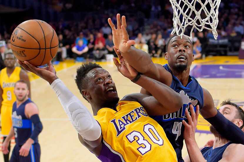 Los Angeles Lakers forward Julius Randle, left, shoots as Dallas Mavericks forward Harrison...
