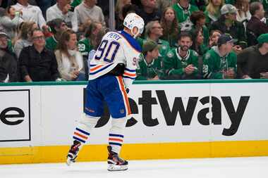 Edmonton Oilers right wing Corey Perry skates off the ice after taking a hit during the...