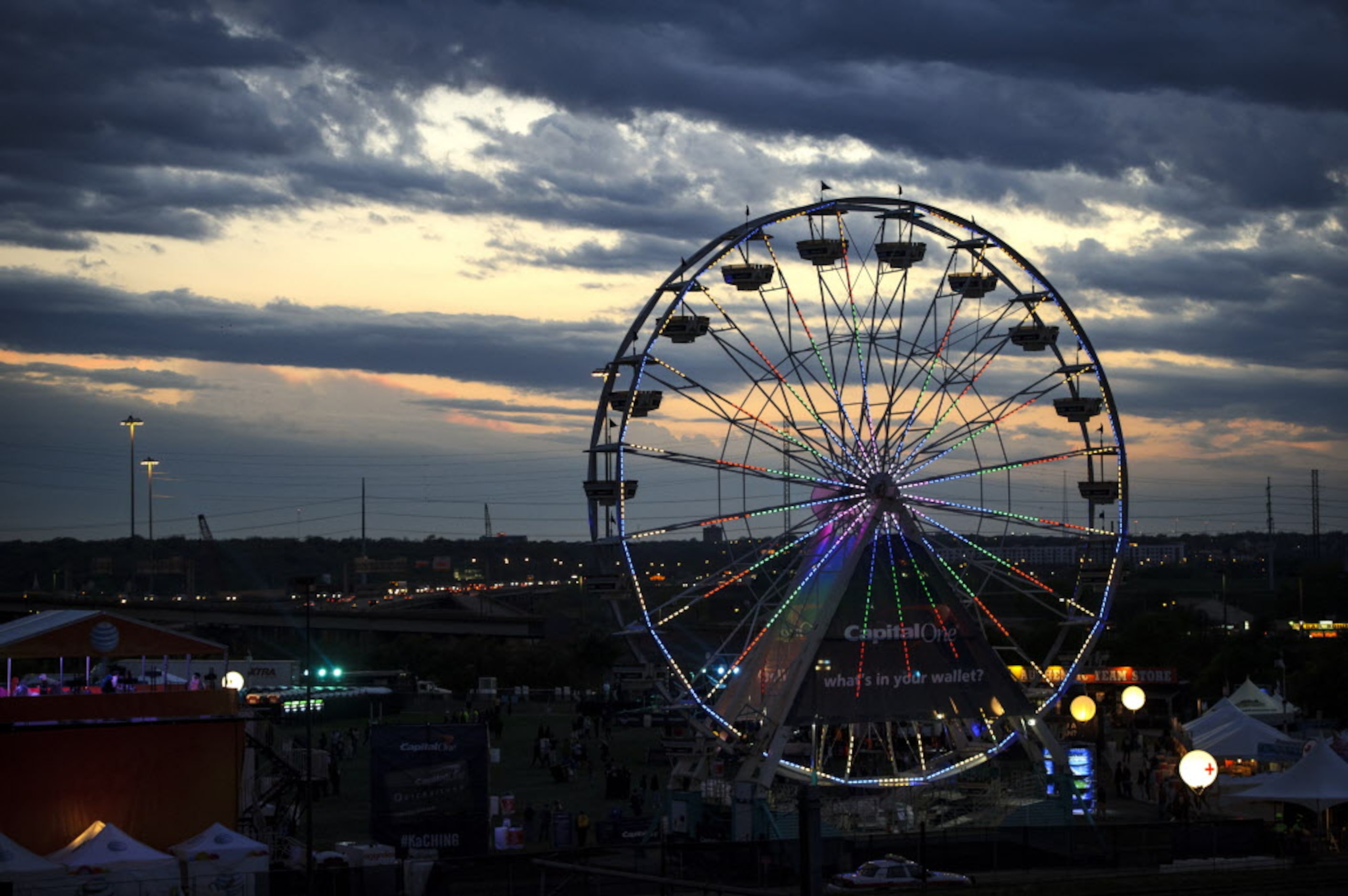 The ferris wheel at the 2014 NCAA March Madness Music Festival lights up the skyline on the...