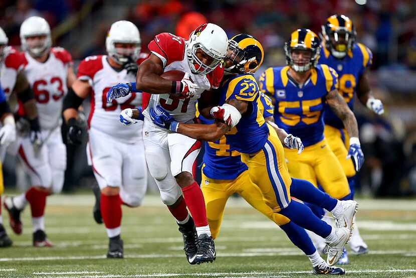 ST. LOUIS, MO - DECEMBER 6: David Johnson #31 of the Arizona Cardinals is tackled by Rodney...