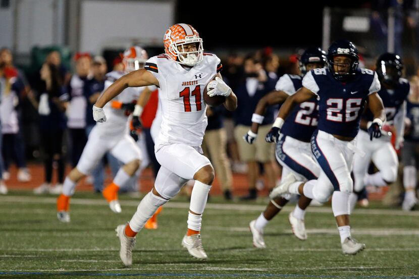 Rockwall's Jaxon Smith-Njigba (11) takes the ball to the end zone for a touchdown in a...