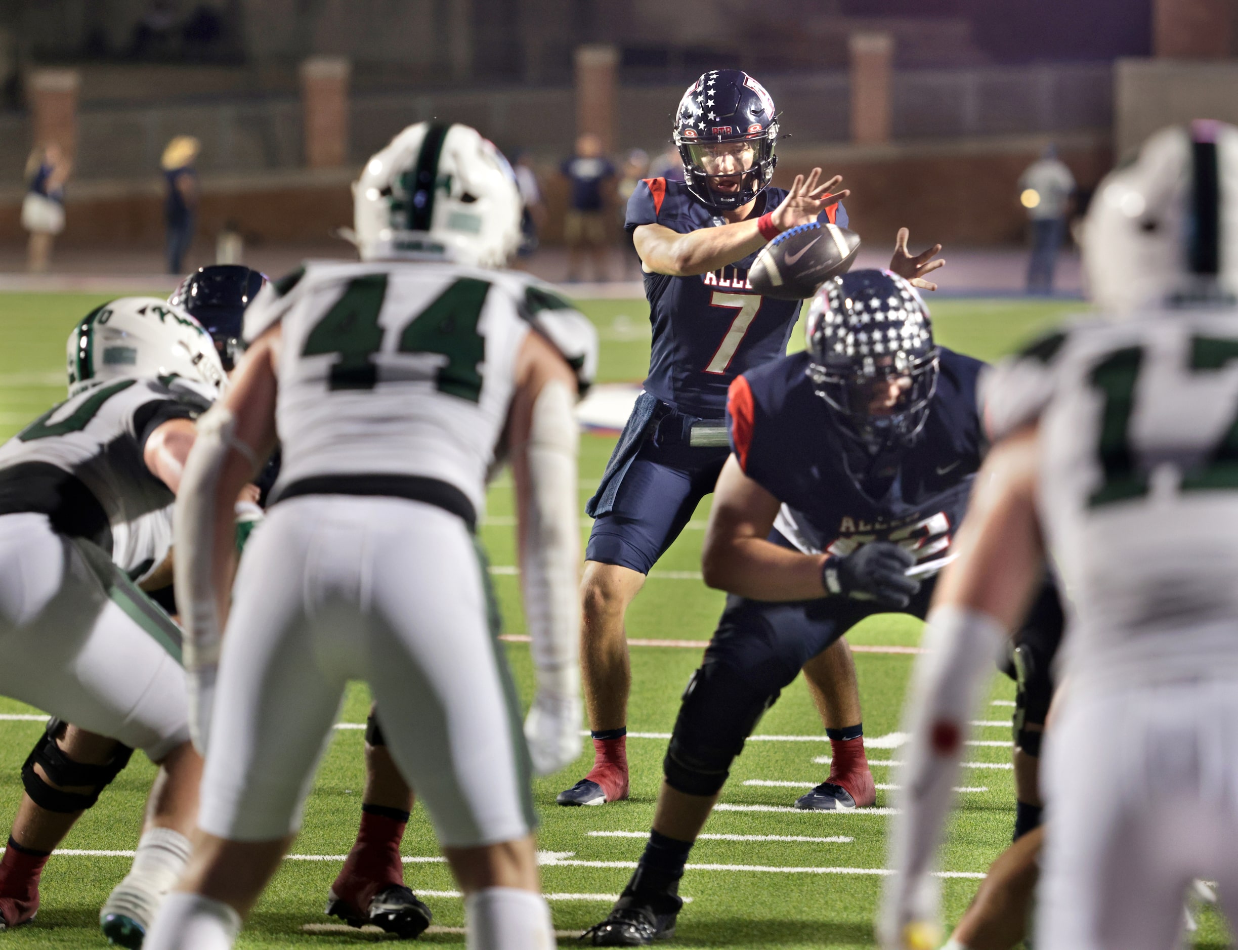 Allen player #7 Brady Bricker receives the snap during the Prosper High School at Allen High...