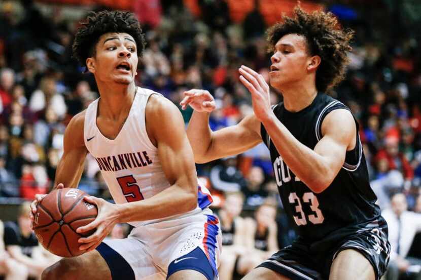 Duncanville junior guard Micah Peavy (5) looks for room against Denton Guyer junior Eli...