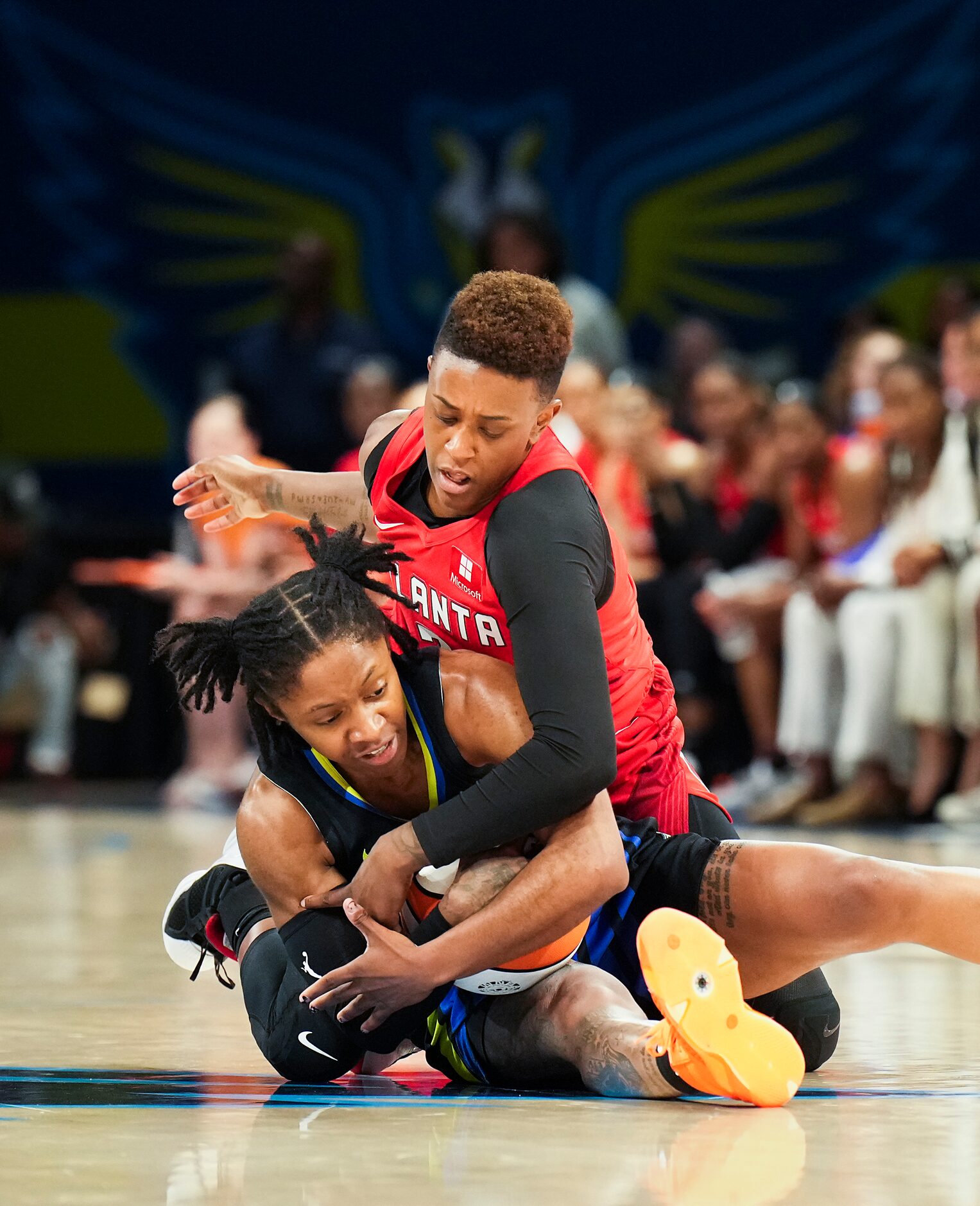 Dallas Wings guard Crystal Dangerfield (11) fights for a loose ball against Atlanta Dream...