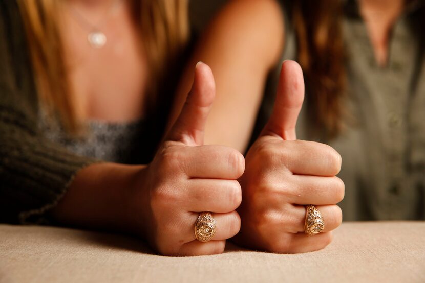 Texas A&M University alumnae Meghan Romere (left) and Abbie Hillis wear their class rings...