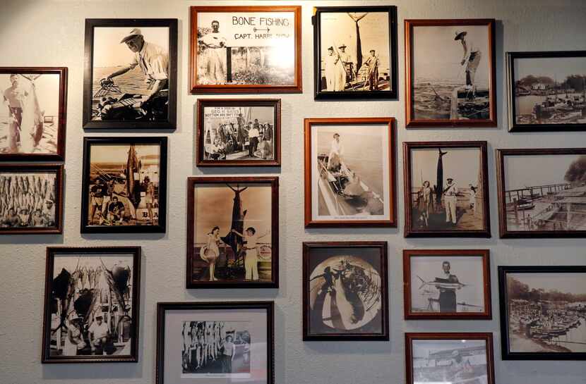Old fishing photos cover a wall at 20 Feet Seafood on Peavy Rd. in Dallas, Tuesday,...