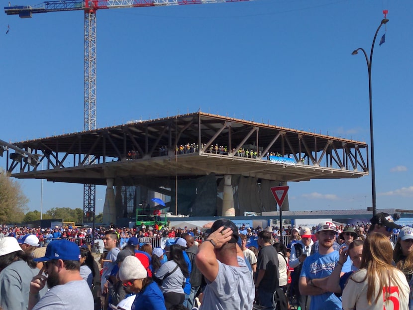 At least 25 construction workers perch atop a makeshift building with some of the best views...