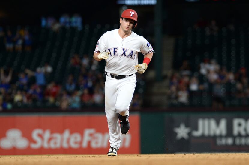ARLINGTON, TEXAS - AUGUST 20: Nick Solak #15 of the Texas Rangers rounds the bases after a...