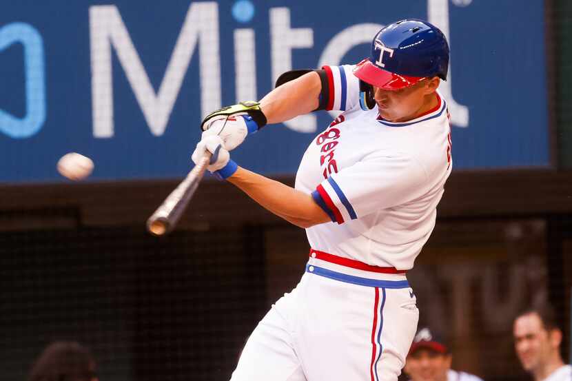 Texas Rangers shortstop Corey Seager (5) hits a homer to right against Atlanta Braves...