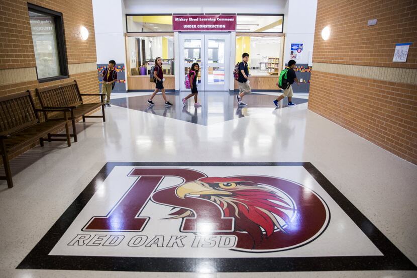 Students walk through the hallway on Wednesday at Donald T. Shields Elementary in Glenn...