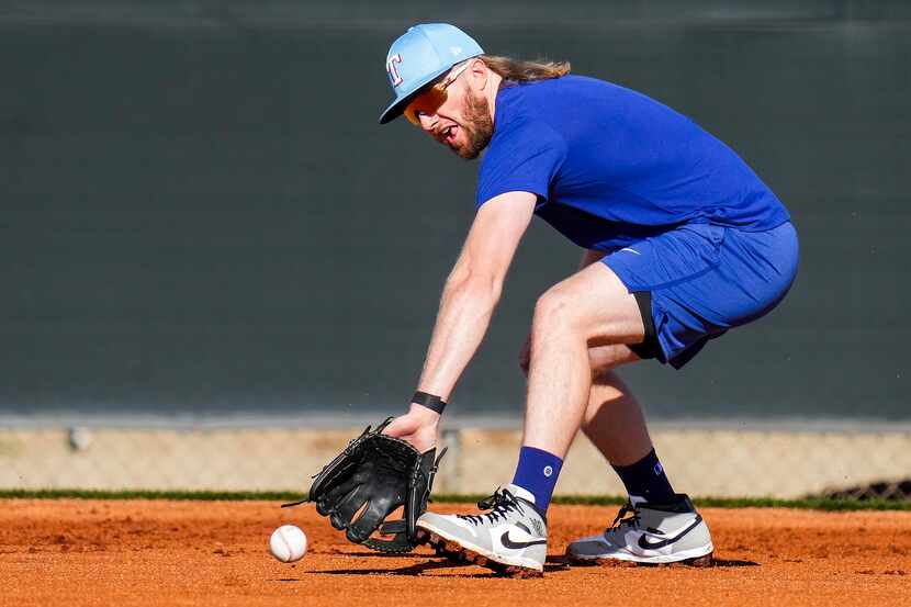 Texas Rangers infielder Davis Wendzel participates in a fielding drill during a spring...