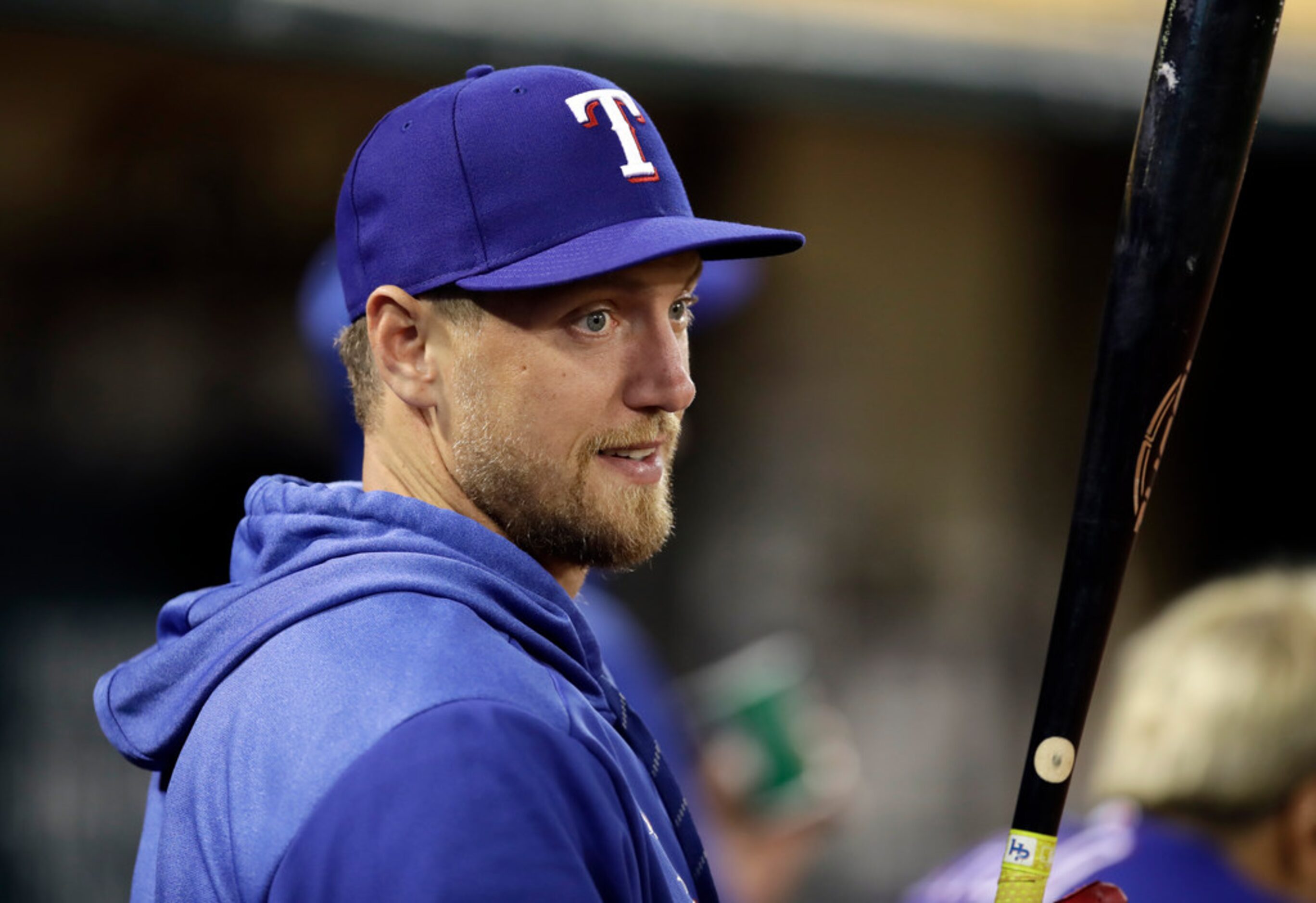 Texas Rangers' Hunter Pence watches the baseball game against the Oakland Athletics from the...