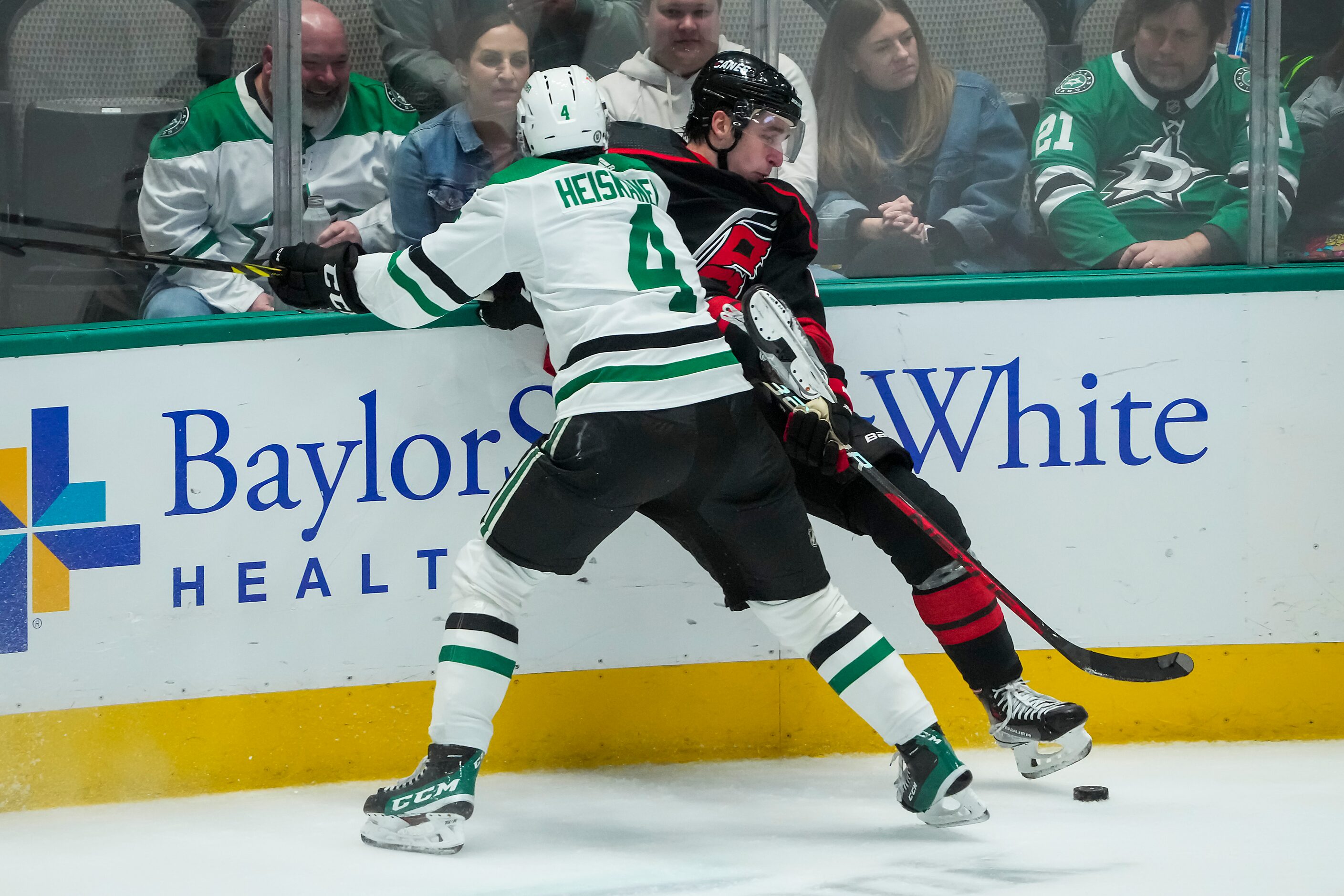 Carolina Hurricanes defenseman Brady Skjei (76) is checked by Dallas Stars defenseman Miro...