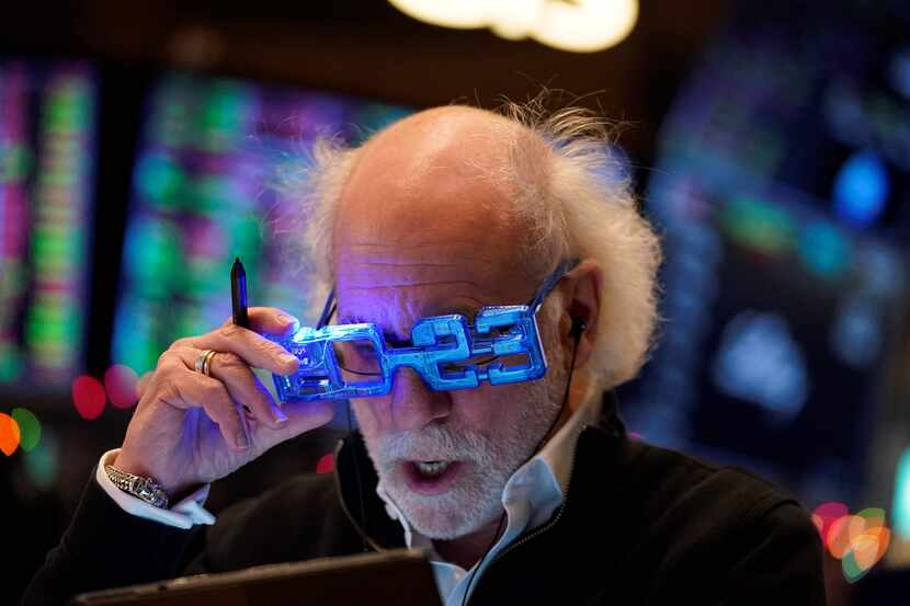 Stock trader Peter Tuchman looks at a clipboard on the floor of the New York Stock Exchange...