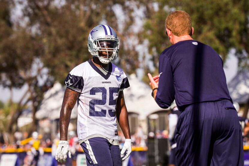 Dallas Cowboys running back Lance Dunbar (25) works with head coach Jason Garrett during...