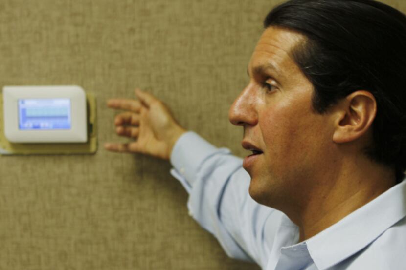 Greg Fasullo, CEO of EnTouch Controls, demonstrates how a high-tech thermostat can help...