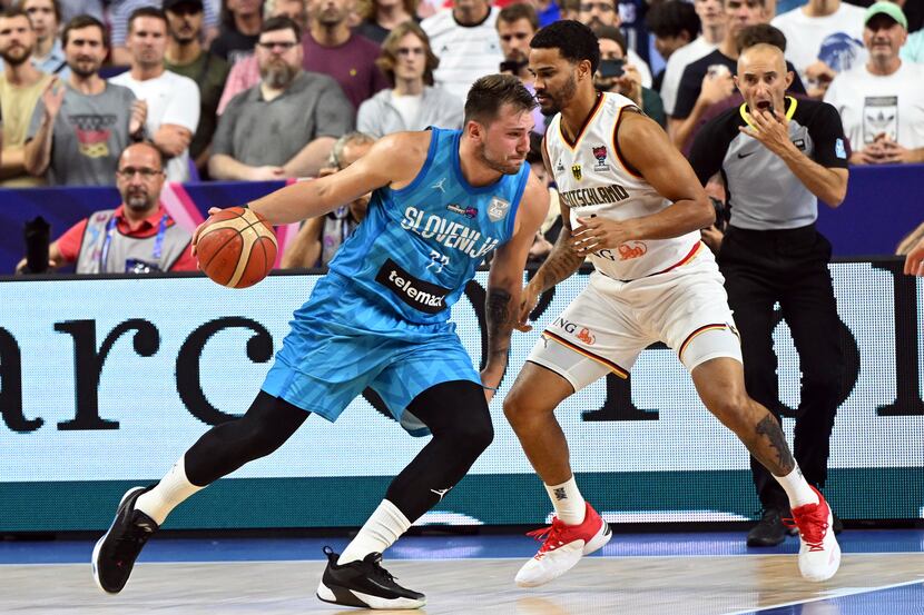 Germany's Nick Weiler-Babb and Slovenia's Luka Doncic, left, fight for the ball during the...