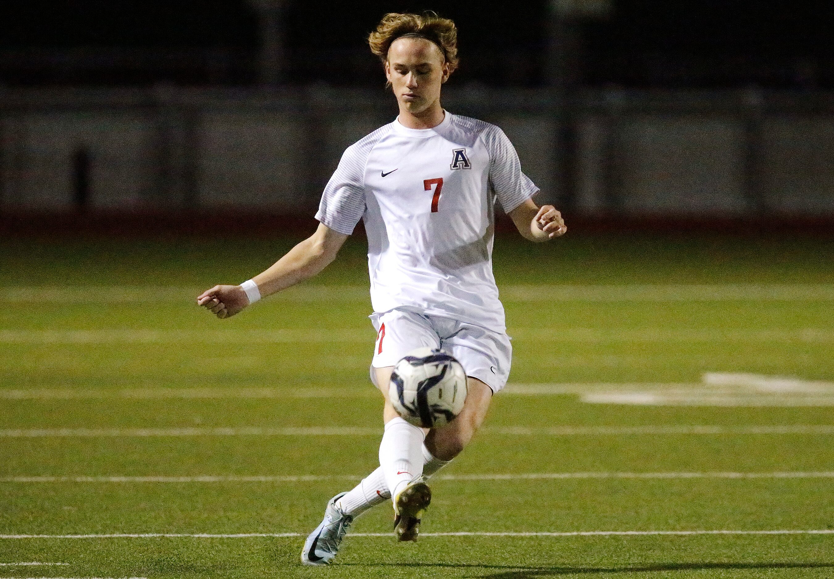 Allen High School defender Dylan Berry (7) passes the soccer ball during the first half as...