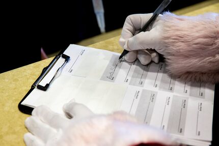 Paul McClain checked in as Santa Claus as he arrived for his checkup at the Texas...