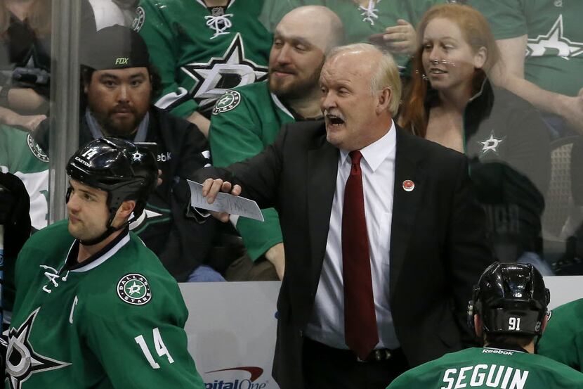 Dallas Stars head coach Lindy Ruff talks with his players including left wing Jamie Benn...