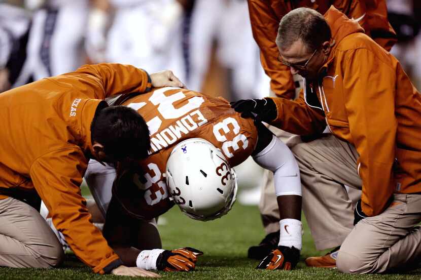 Texas linebacker Steve Edmond receives attention following in injury during an NCAA college...