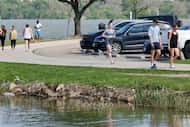 People walk and run along the White Rock Lake Trail at White Rock Lake on Monday, April 3,...