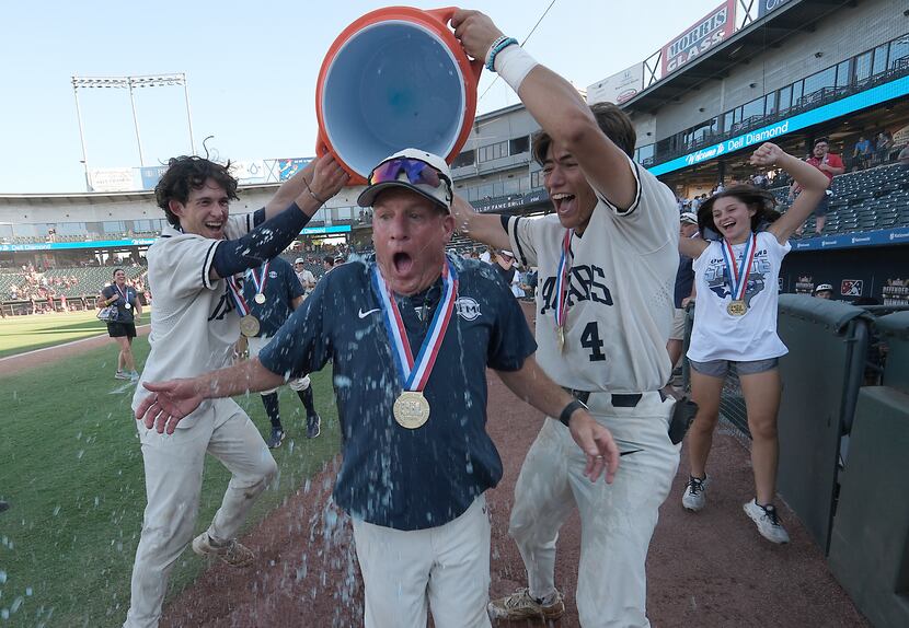 Flower Mound Zane Becker, (17), and Ryder McDaniel, (4), pour a bucket of gatorade over...