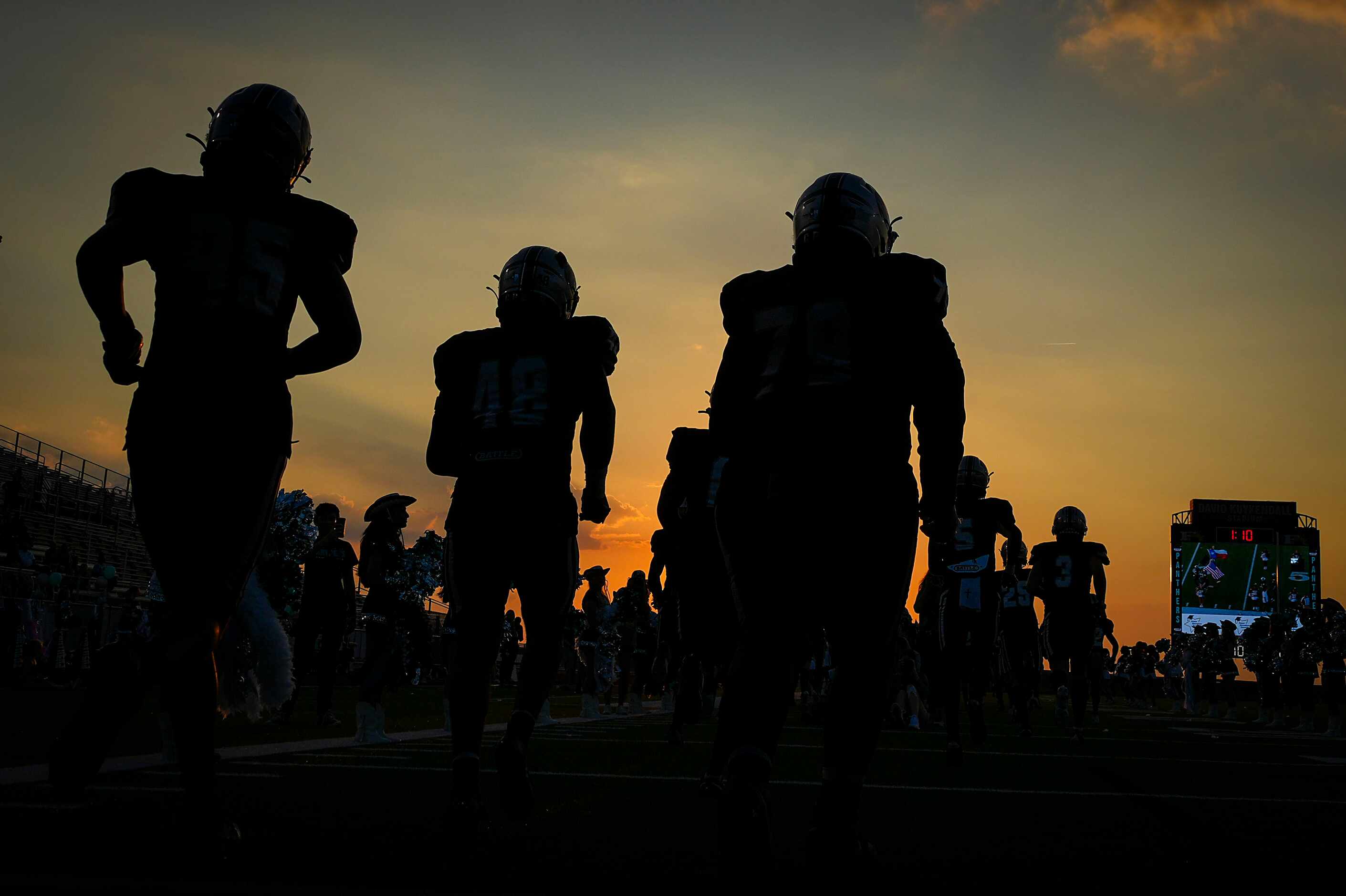 Panther Creek players take the field before a District 7-4A Division I high school football...