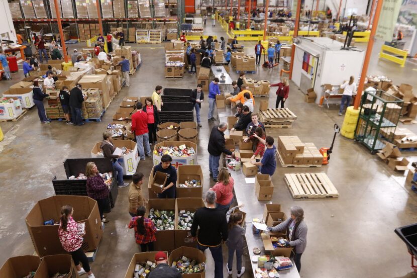 Volunteers help sort food at The North Texas Food Bank.  (File Photo)