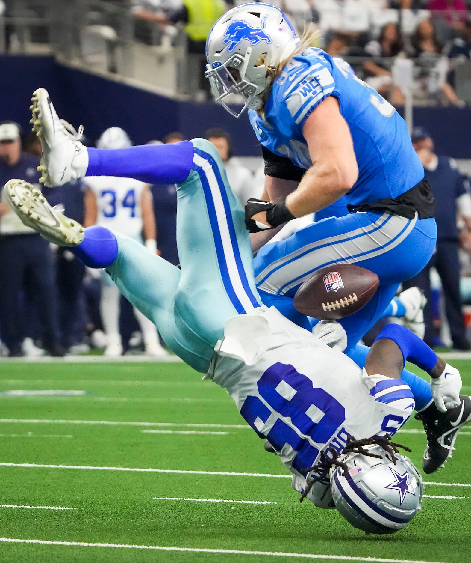 Dallas Cowboys wide receiver Noah Brown (85) fumbles as he is flipped upside down while...