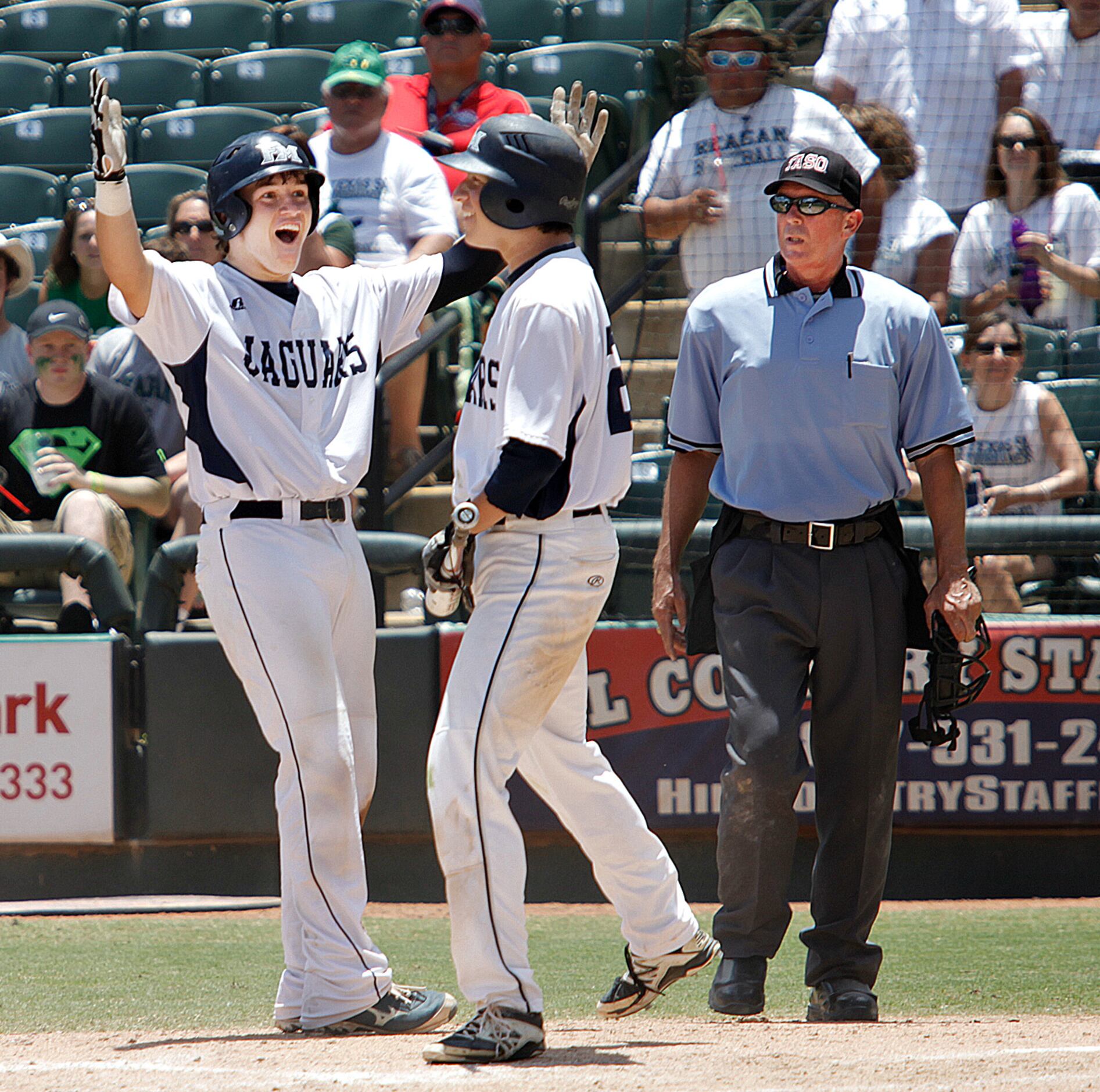 After running in the final run making it 10-0, Flower Mound player Mitch Andrews (5, left)...