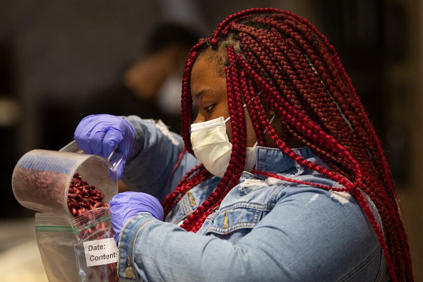 Essence Evans,17, scoops beans into gallon-size bags at Cafe Momentum. The restaurant's...