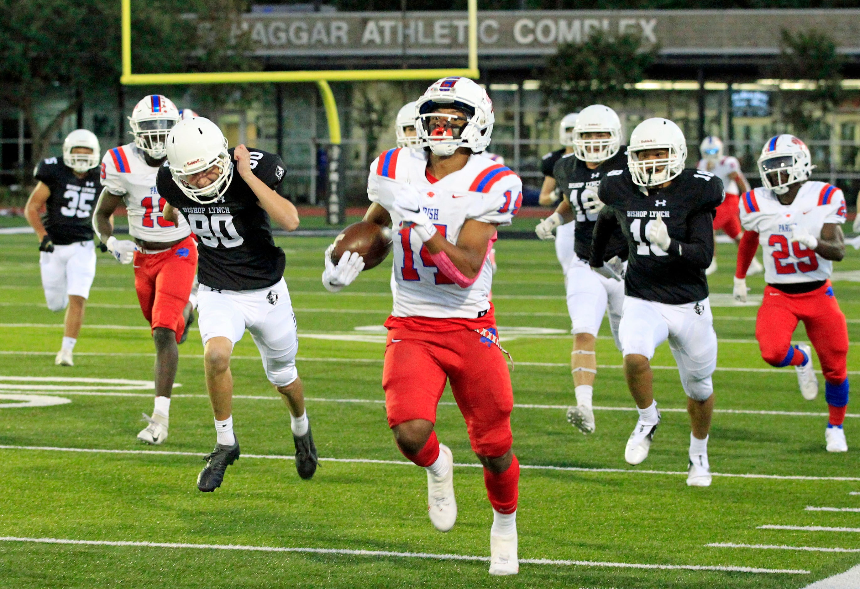 Parish Episcopal’s Daniel Demery (14) runs the game opening kickoff back for a touchdown...