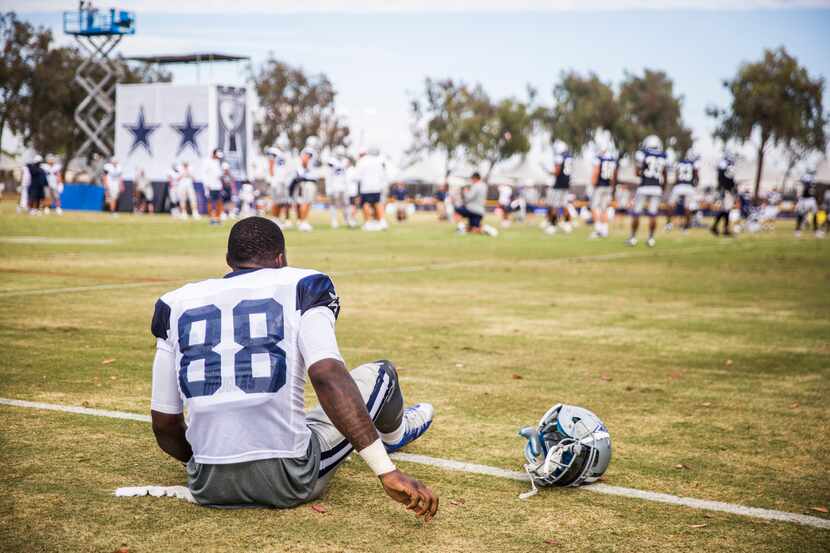 Dallas Cowboys wide receiver Dez Bryant sits on the field after feeling a strain in his left...