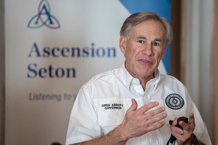 Gov. Greg Abbott speaks  to the local media before receiving a dose of a Pfizer-BioNtech...
