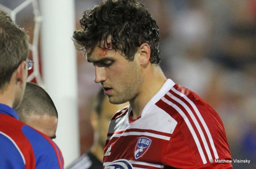 13 April 2013 - FC Dallas defender George John (#14) gets cleaned up after being hit by a...