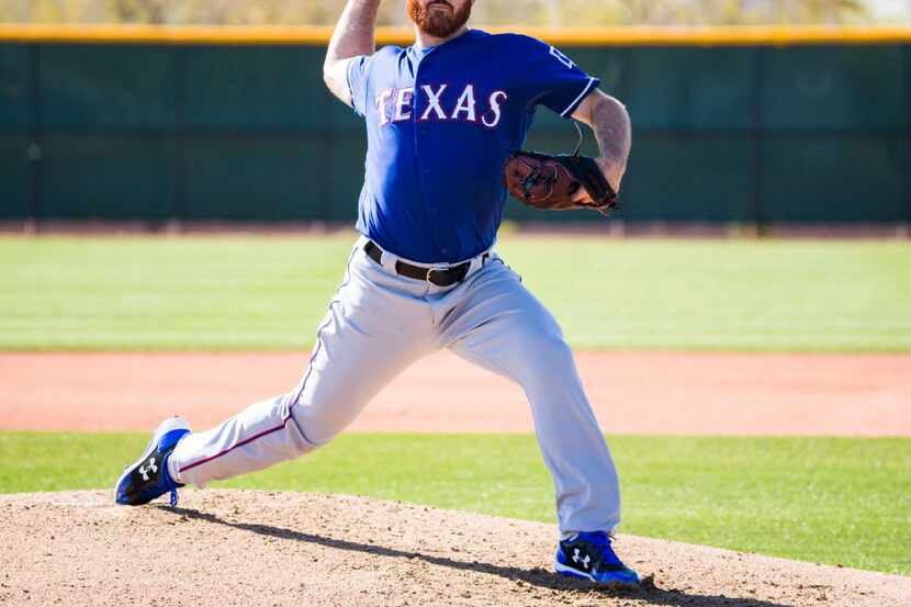 Texas Rangers relief pitcher Sam Dyson (47) pitches a simulated game during a workout at the...